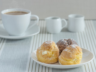 a dish of chou cream with a cup of tea or coffee for an afternoon break.