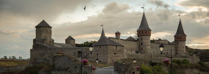 Impressive view at medieval Kamenets-Podolskiy Castle  at sunset background, in Ukraine