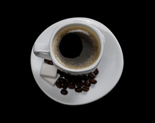 White cup of coffee with beans isolated on black background
