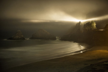 Scenic view of shore against Yaquina Head Light during night