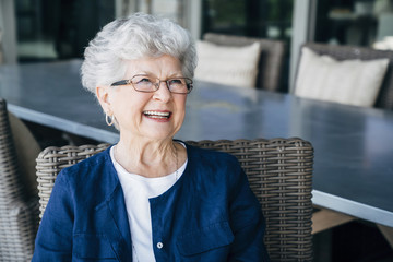 Smiling senior woman relaxing on porch
