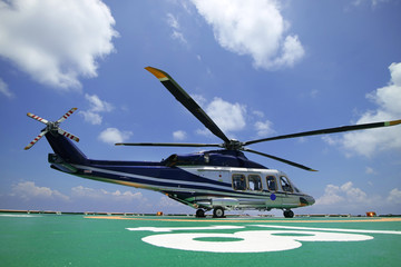 Helicopter or chopper land at oil and gas platform area for get and sent passenger from onshore...