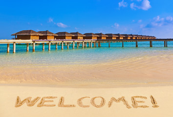 Word Welcome on beach