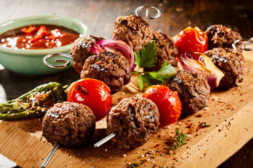 Savory meat balls on skewers with roasted veg