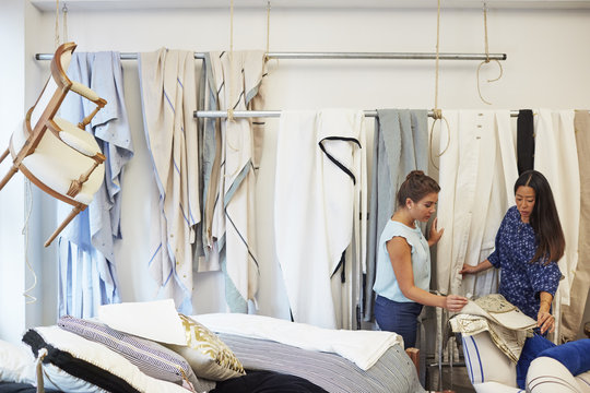 Interior designers selecting curtain samples in workshop