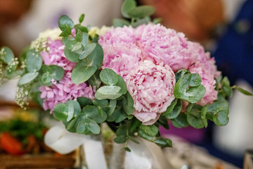 Wedding bouquet of flowers of pink peony. The concept is a holiday, a wedding, marriage, a ceremony.