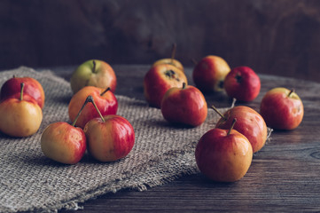 Red autumn apples on a wooden table. Selective focus