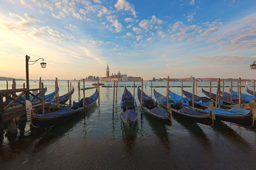 Fototapeta na wymiar Venetian gondolas at sunrise