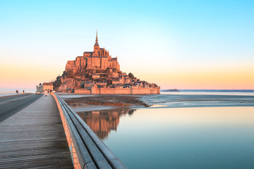 Fototapeta premium Morning light on Mont Saint Michel and it's reflection in Normandy - France