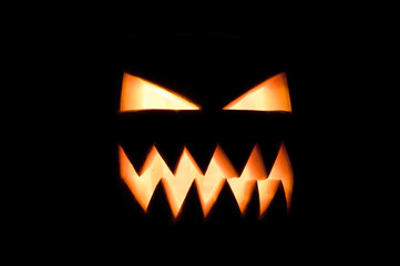 Fototapeta premium Glowing Halloween pumpkin in the dark.