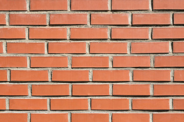 Brick wall background, texture of red stone blocks closeup