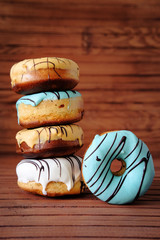Fresh sweet.doughnuts with multi colored icing and chocolate
