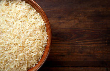 Bowl of rice on textured wooden table