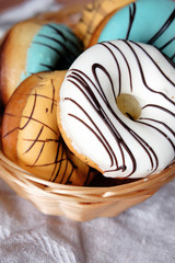 Fresh sweet doughnuts with multi colored icing and chocolate