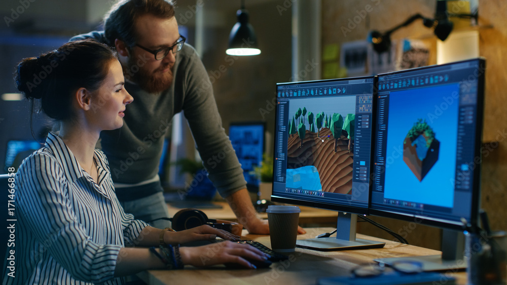 Poster Female Game Developer Has Discussion with Male Project Manager While Working on a Game Level on Her Personal Computer with Two Displays. They Work in a Modern Loft Office Creative Environment.