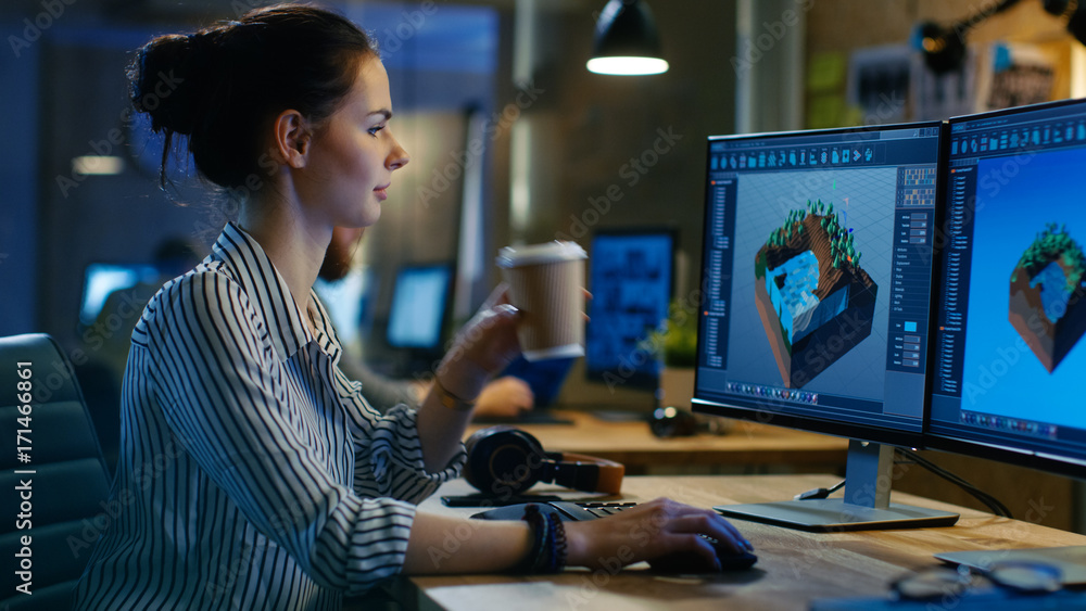 Poster Female Game Developer Works on a Level Design on Her Personal Computer with Two Displays, She Works Late and Drinks Coffee. She Works in a Creative Loft Office Space.