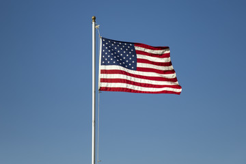 American flag on the blue sky