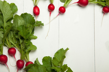 Radishes on a white wooden background