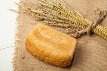 white bread or sliced bread in the basket on wooden floor with sack cloths.