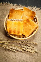 Toast the bread on a black wooden background