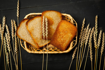 Toast the bread on a black wooden background