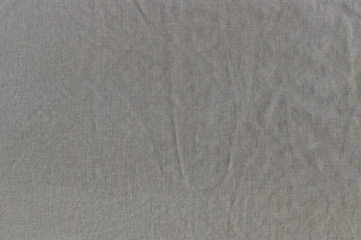 The wrinkled texture of linen cloth brown.