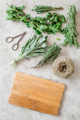 making spices with fresh herbs and greenery for cooking stone kitchen table background top view mockup