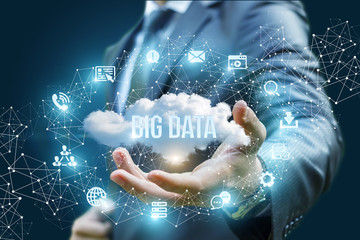Businessman showing a cloud with the words big data .