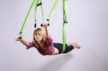 The girl performs exercises in a hammock for yoga / Photo taken in Russia, in the city of Orenburg,...