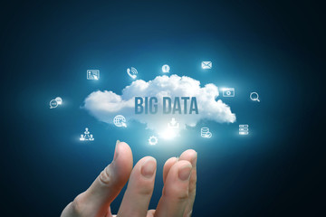 Hand showing a cloud with the words big data .