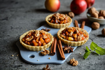 Fruit tartlets filled with caramelized apple pieces, cinnamon and walnuts