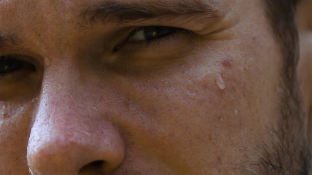 Epic extreme close-up shot. Eye and nose. sweat man outdoor in park. Drop of water on his face macro slow motion high-speed fps rapid camera.
