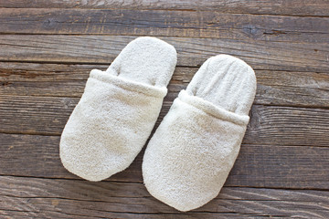 Terry house slippers on old wooden floor