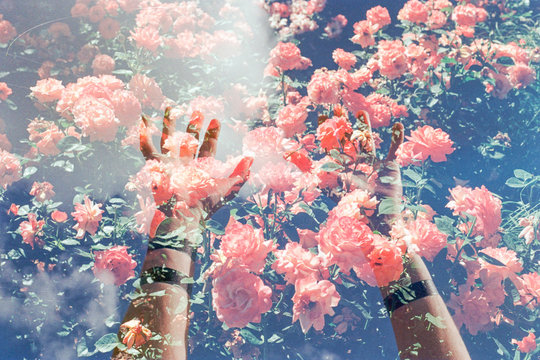 Double exposure hands and flowers