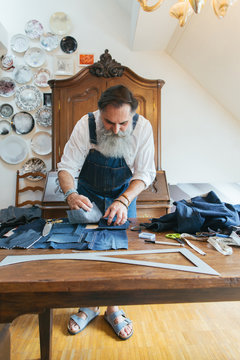 Indoor Portrait of Fashionable Senior Tailor Working on Boro Bag