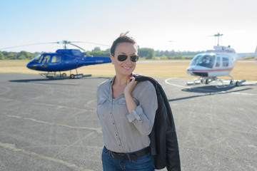 pilot woman on helicopter background