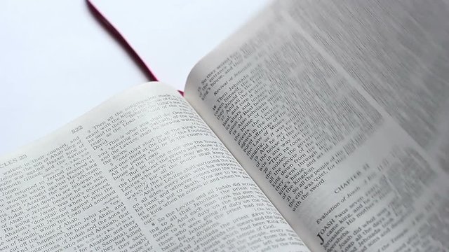 The Man Leafing Through The Page Of Bible