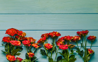 Still life with roses flowers on the wooden background