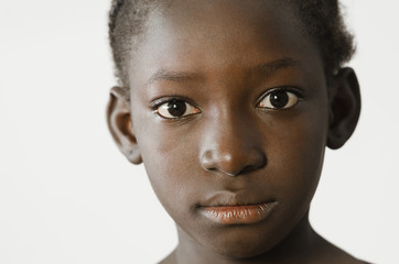 Sad African child showing her face for a portrait, sadness despair symbol, isolated on white