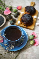 a fine breakfast, a mug of tea, fresh rolls with poppy seeds and poppy flowers.