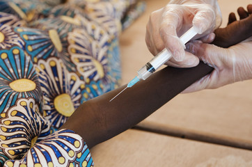 Young African black boy getting a vaccination injection
