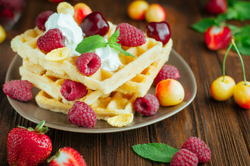 Belgian waffles with berries, whipped cream and grated chocolate