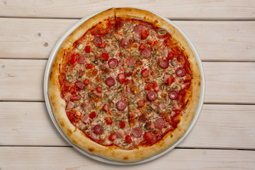 Top view of pizza pepperoni on wooden table