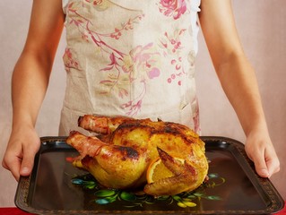 food photo cook in apron is holding fried chicken 