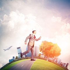King businessman in elegant suit running on green globe with mod