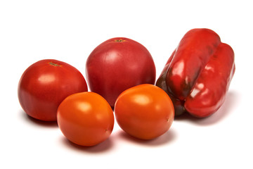 Still life with sweet pepper, yellow and red tomatoes. Isolated on a white background