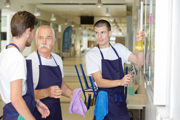 Male cleaning team in discussion