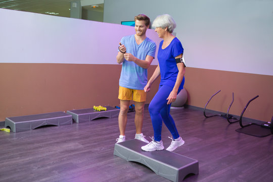 elderly woman using a stepper for fitness