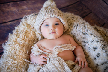 Cute infant Newborn baby boy in a knitted hat.