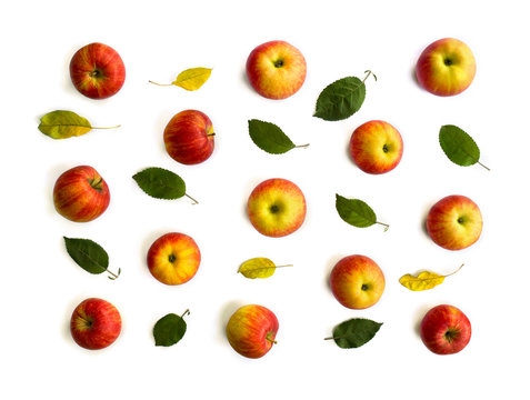 Ripe yellow red juicy apples and leaves apple tree on white background. Top view, flat lay. Texture.